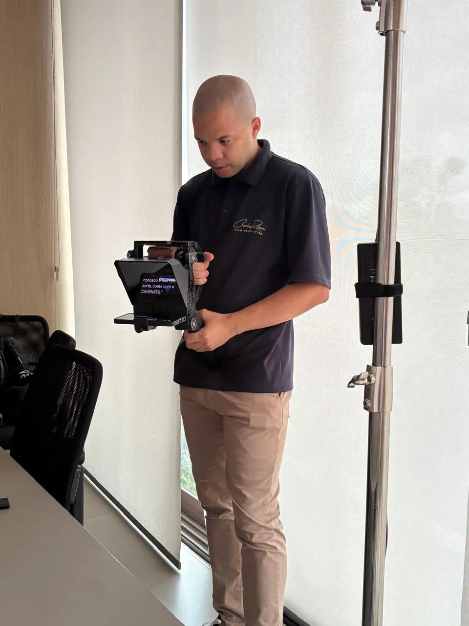 Charles Ribeiro operando um teleprompter em uma produção audiovisual